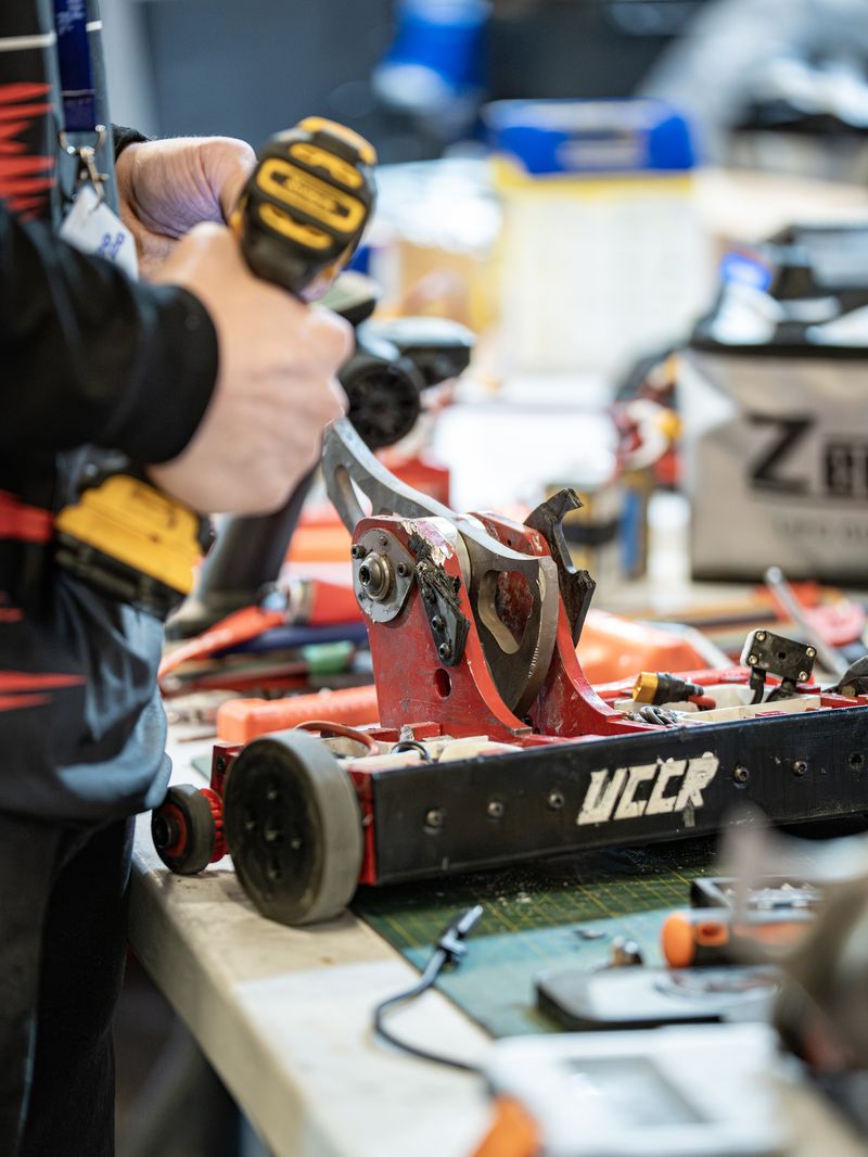 A UCCR member working on a robot